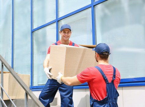 Professional movers loading boxes and furniture into a van