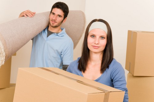 Movers carrying furniture through a Sidcup property